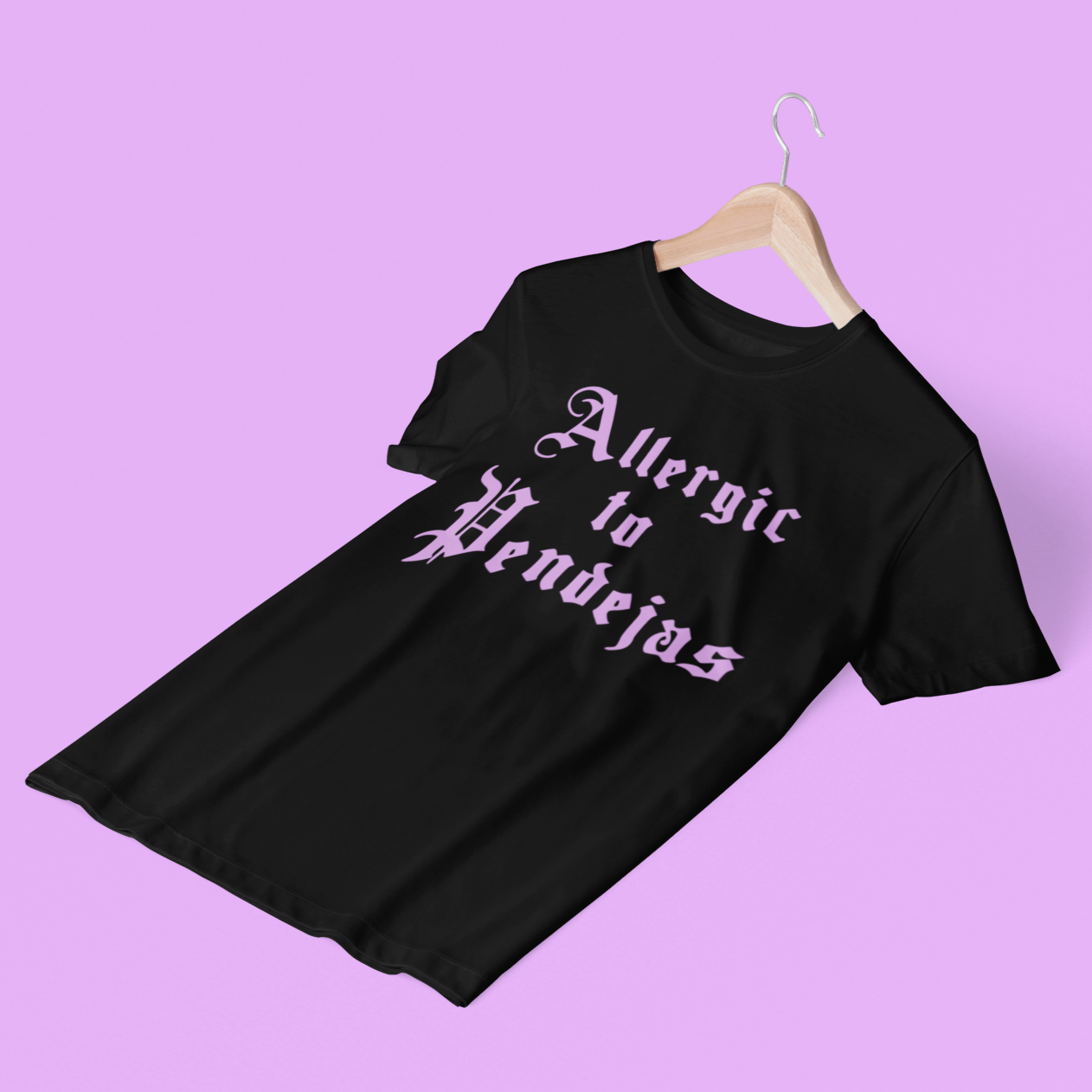 Black t-shirt with 'allergic to pendejas' written in pink cholo-style letters for Latinas