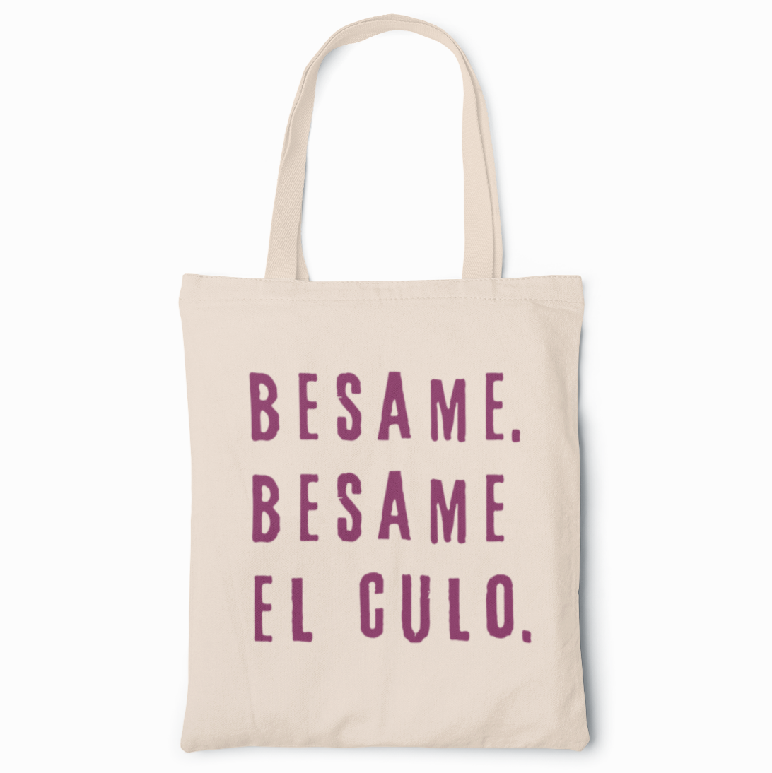A funny spanish canvas tote bag for latinas with the words 'Besame. Besame El Culo' in deep purple vintage lettering