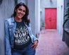 Image of a woman wearing a black t-shirt with the text "Only the best moms get promoted to abuela" and shooting stars as part of the design