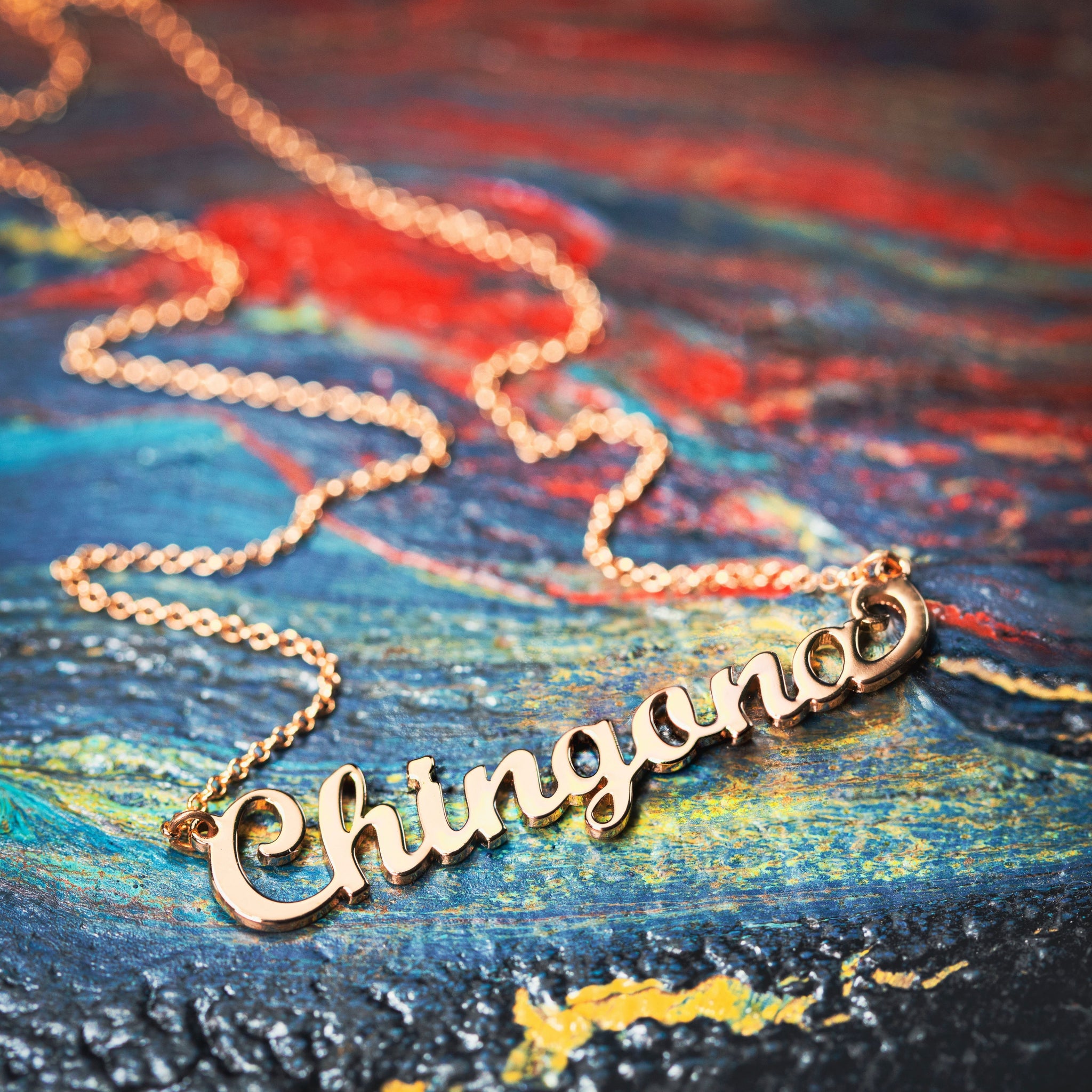 Elegant sterling silver women's necklace plated in gold, featuring the word 'Chingona' in a cursive font.