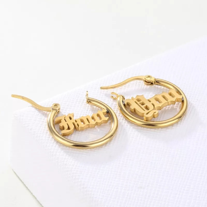 Gold chunky hoop earrings with customizable lettering inside the hoop. the  font is Old English.  Earrings for Spanish speakers