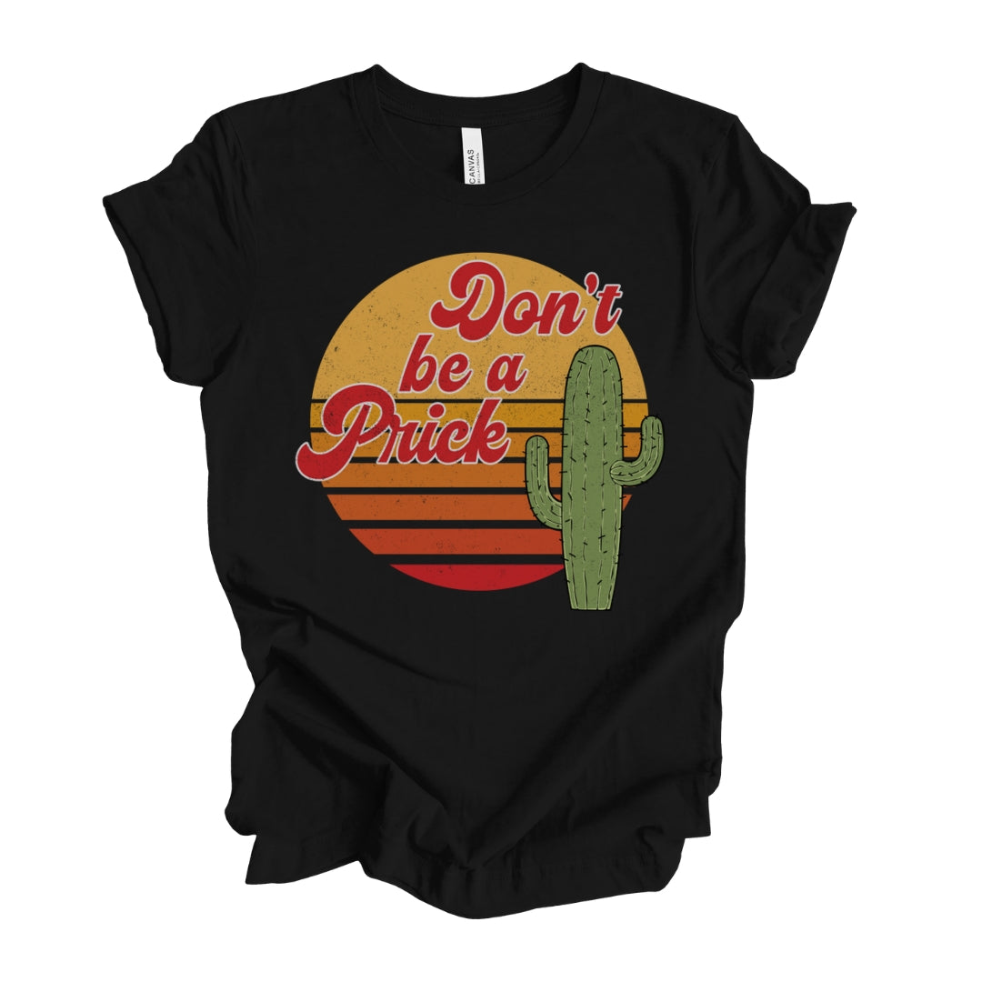 Make a statement with this humorous black 'Don't be a prick' T-Shirt for women, featuring a cactus graphic in red cursive text