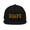 Black OG latino snapback cap baseball hat with embroidered gold letters that say, "GUAPO"