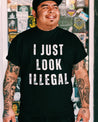 mexican man wearing a Funny shirt for latino men, with the statement 'I Just Look Illegal' in a street style font on black fabric