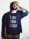 Latino wearing a Streetwear-style t-shirt for Mexican and Hispanic men, featuring the graphic 'I Just Look Illegal' on a blue shirt