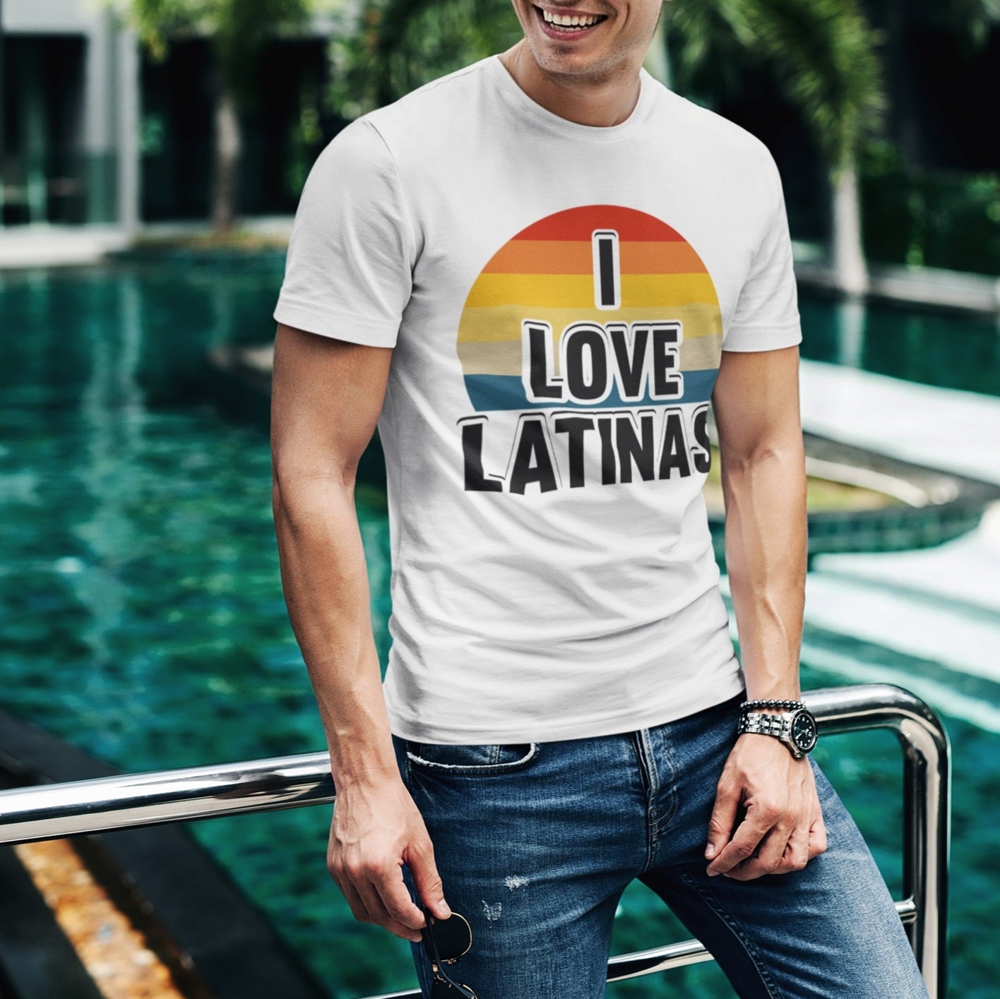 Latino man wearing a rounded rainbow multi-colored design on a white t-shirt with bold black 'I Love Latinas' phrase