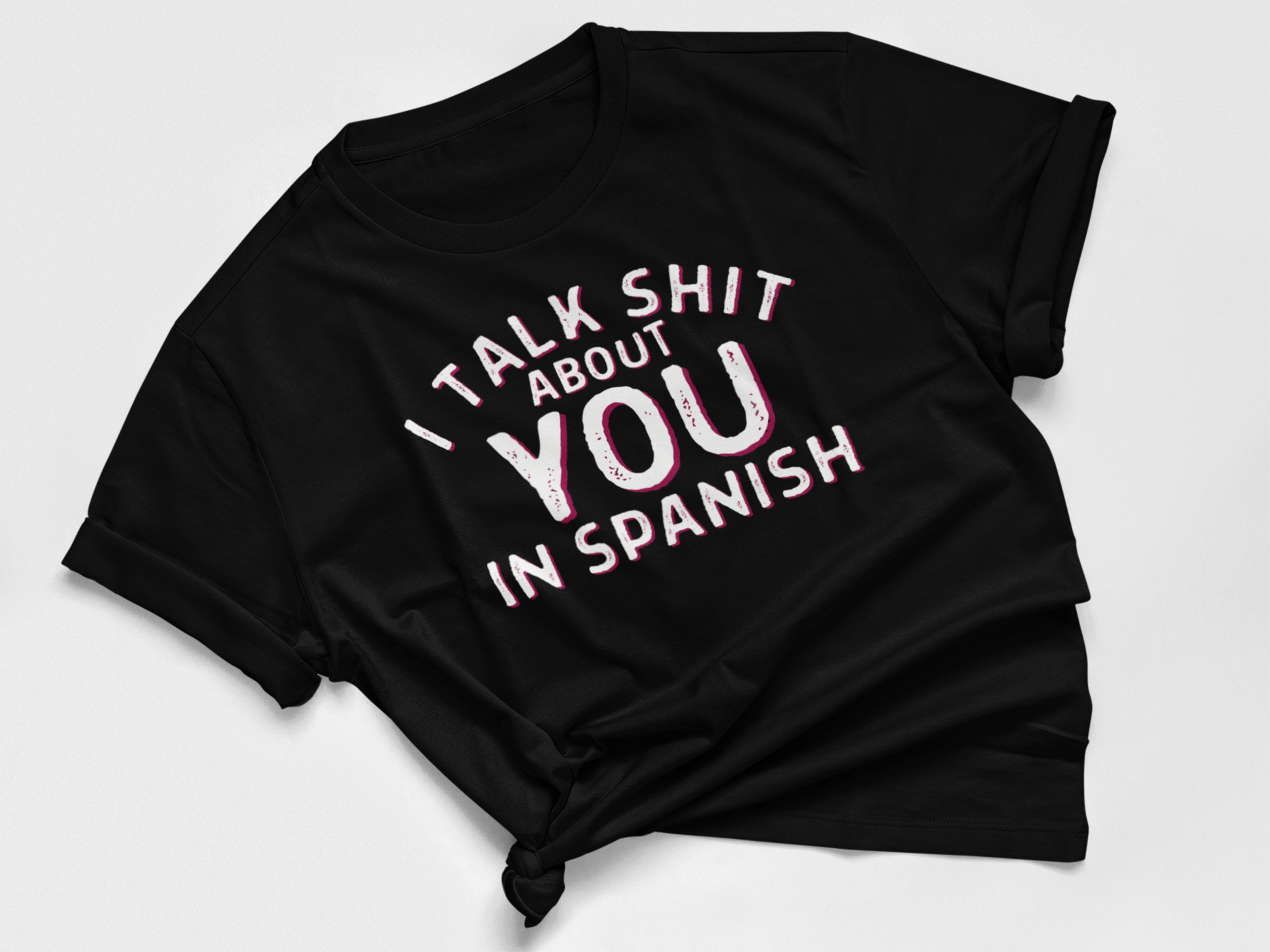 Women's black t-shirt with funny 'I talk shit about you in Spanish' graphic in bold text for Spanish-speakers