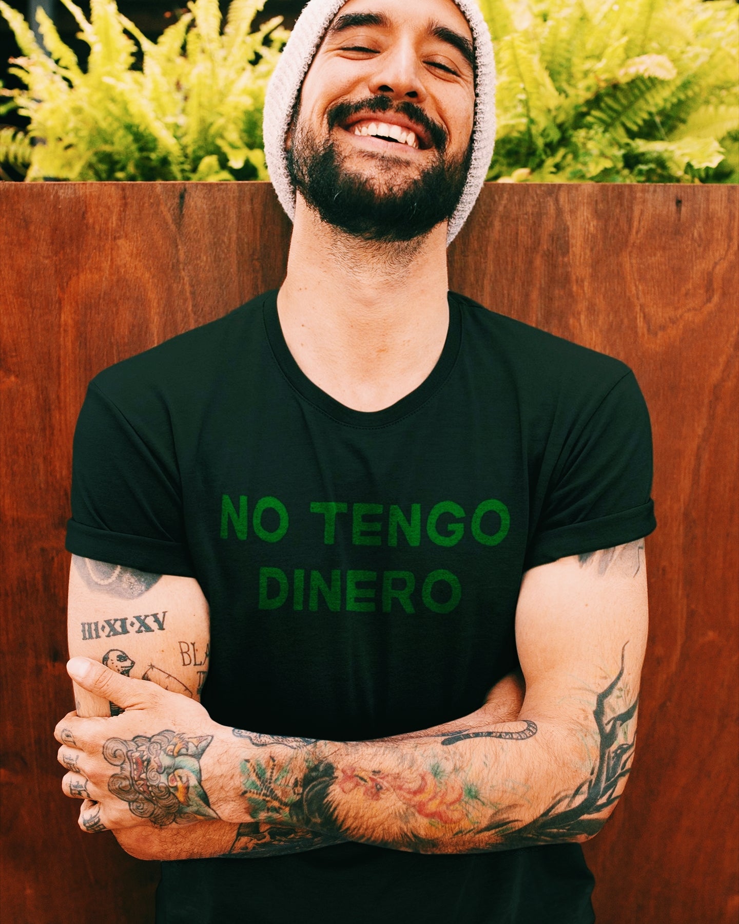 Latino man wearing Black t-shirt with green text reading 'no tengo dinero'