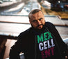 latino man wearing Graphic Tee: Black T-Shirt with Mexcellent Faded Text in Green, White, and Red Latin-Inspired Design