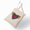 A graffiti-style heart with golden wings adorns this canvas tote, representing the concept of freedom