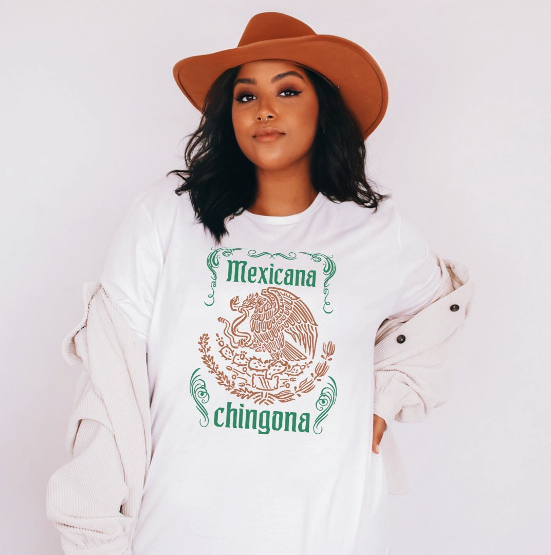 mexican woman wearing an empowering white t-shirt for Mexican women, featuring a crested caracara graphic and the text 'Mexicana Chingona'