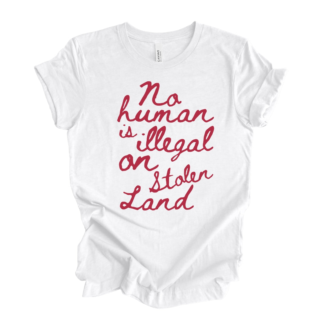 Women's 'No human is illegal on stolen land' T-Shirt with handwritten text in red on white