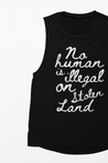 powerful 'No human is illegal on stolen land' T-Shirt for women with  white handwritten text on a black background