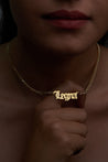 Gold personalized custom name necklace in old English font.