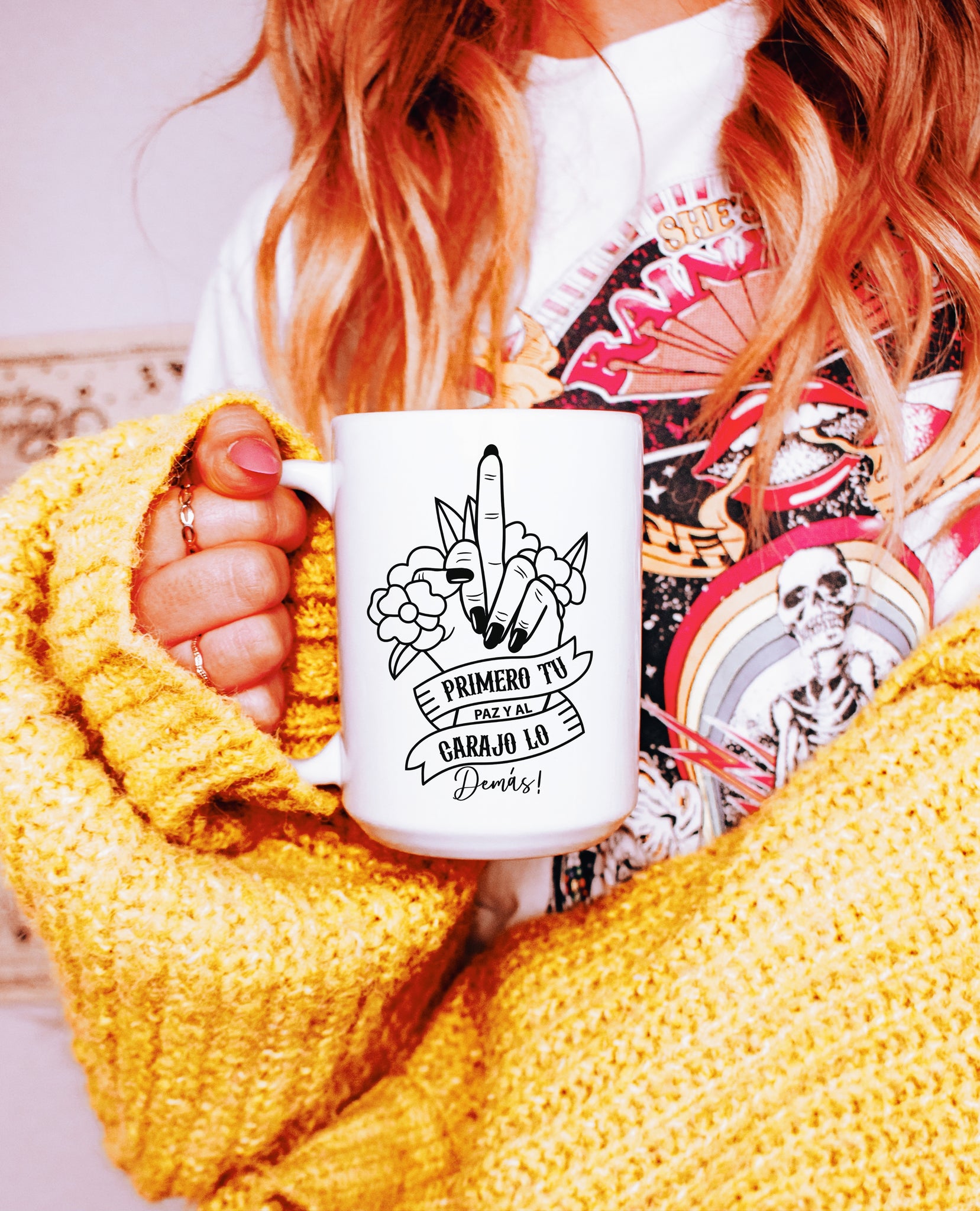 woman holding a Funny tall white mug featuring a raised middle finger and the message 'primero tu paz y al carajo lo demas’