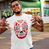 Hispanic man wearing a Funny and empowering Latino white t-shirt for Spanish speakers. the graphic is tattoo-style lucha Libra mask. the text on the mask states "sin lucha, no hay Victoria"