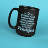 Angled view of a Funny tall black mug for Latinos and Spanish speakers.  In light blue lettering, the mug says "Studies have shown that intelligent people swear more than stupid pendejos".