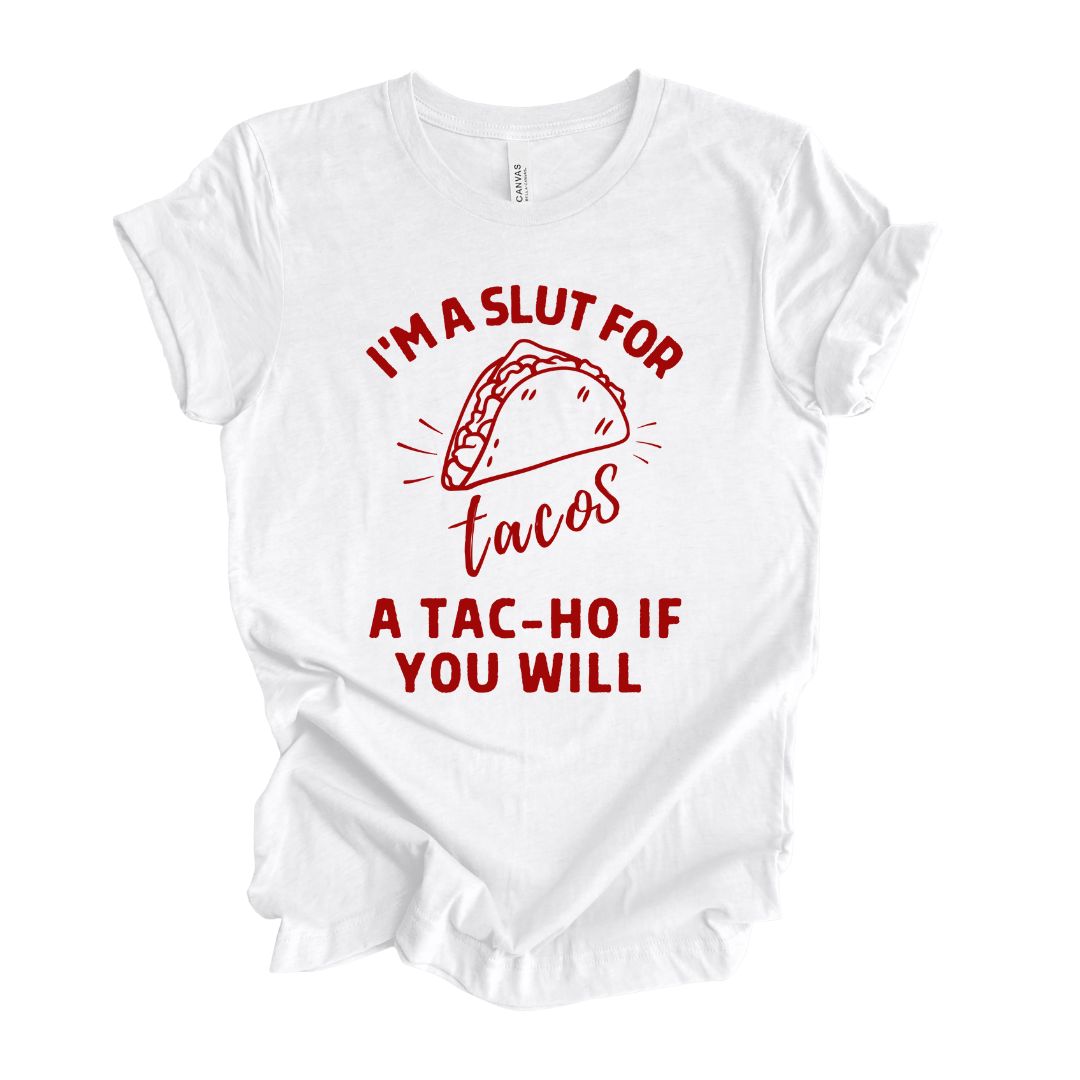 Funny white T-shirt for Latinos, Spanish speakers, and taco lovers.  In classic red lettering, the graphic says "I'm a slut for tacos, a tac-ho, if you will".  There is also a stylized taco on the shirt