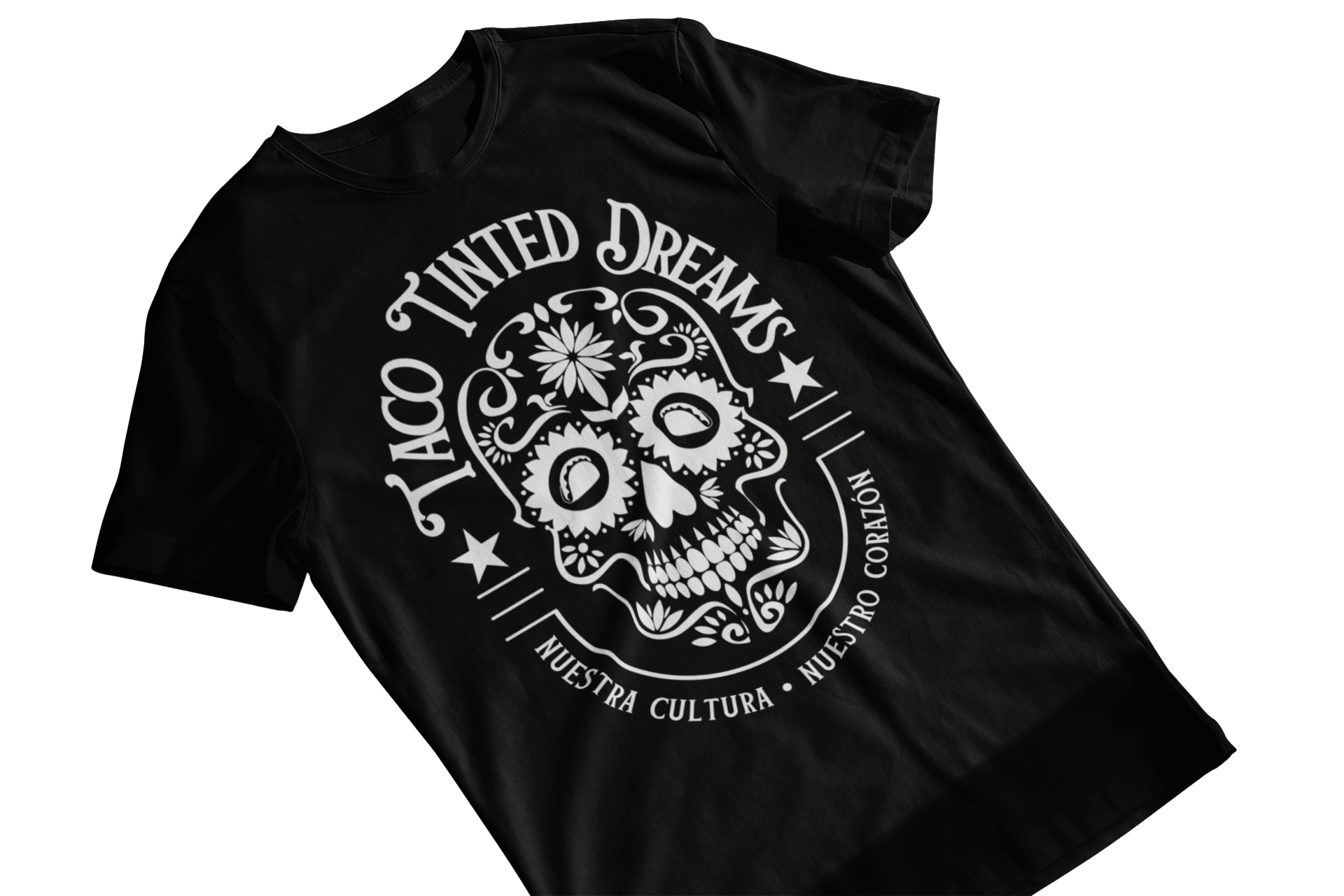 T-shirt with tattoo-style Mexican sugar skull calavera logo and text "taco tinted dreams" and "nuestra cultura, nuestro corazon"